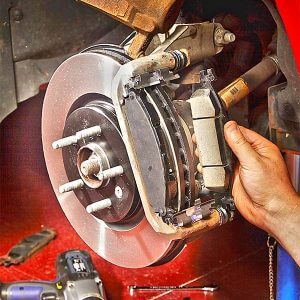 Repair shop replacing car's brake pads 